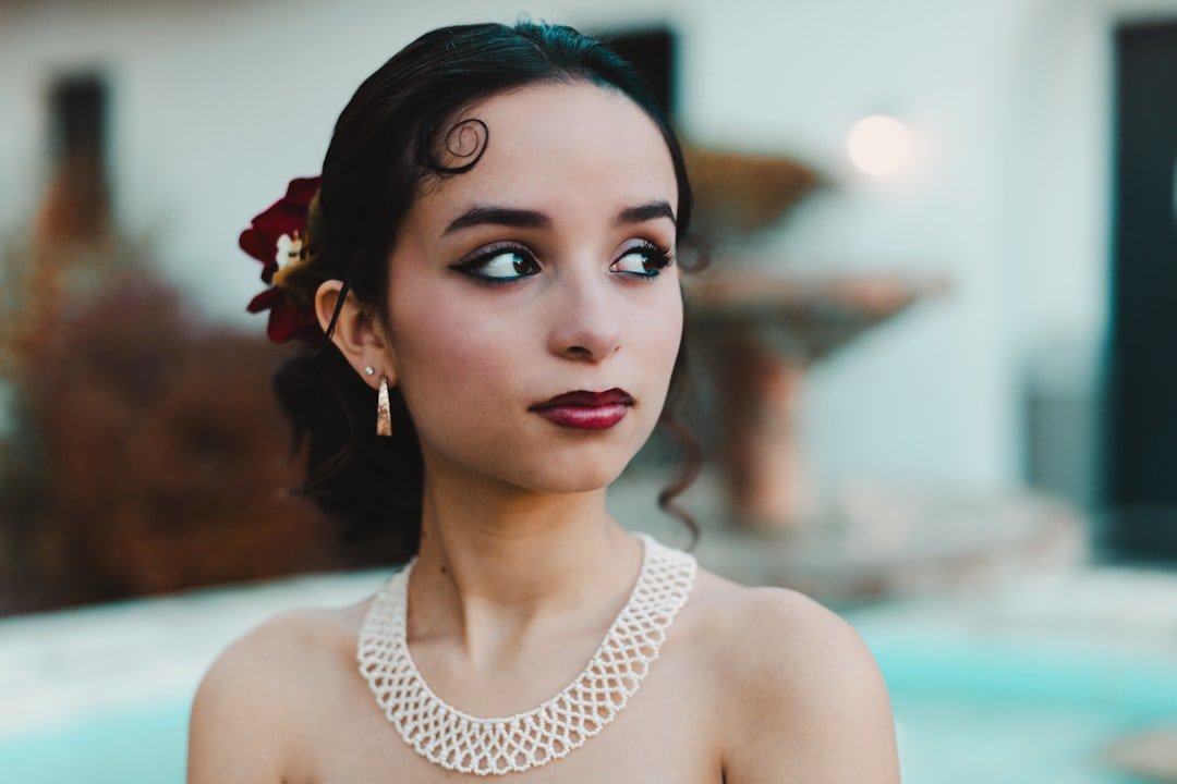 Elegant accessories for plus size wedding guest outfits including pearl earrings, clutch, block heels, and gold necklaces