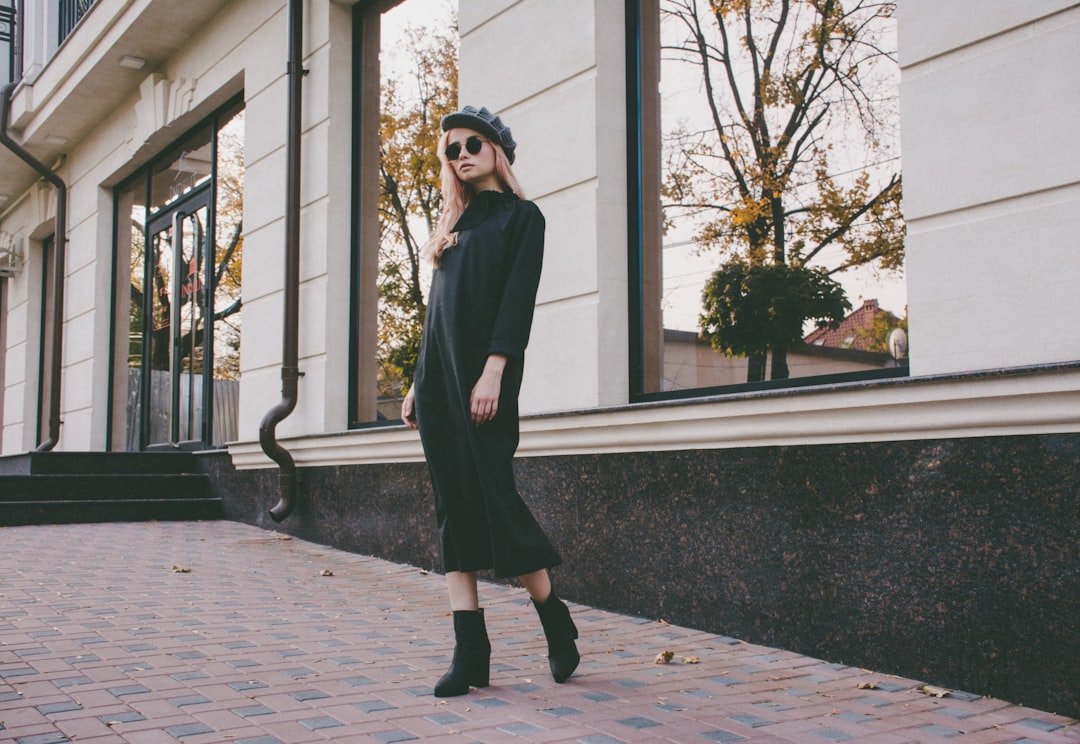 Flat lay of black leather jacket, sweater, and boots symbolizing why black dominates fall fashion.