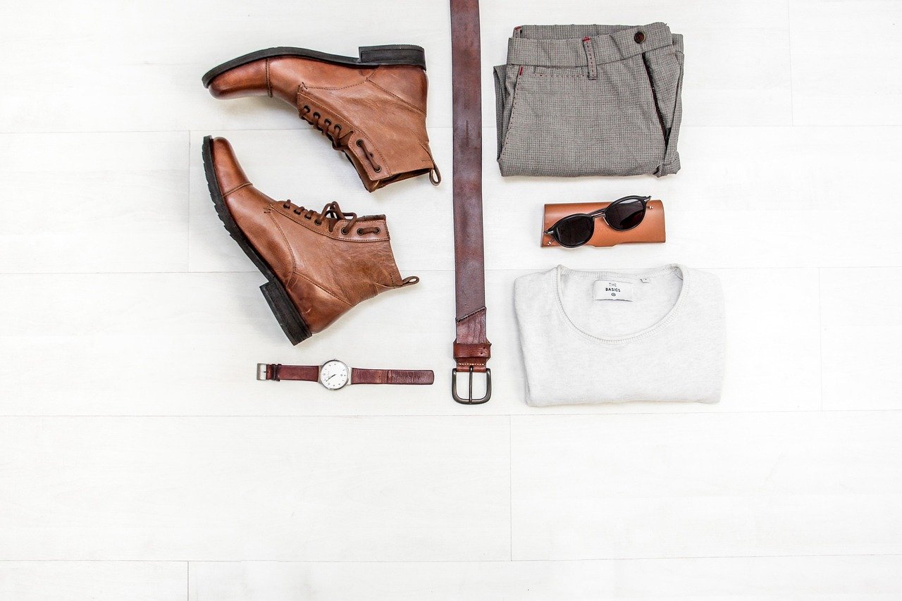 Organized neutral-toned closet with essential basics like white shirts, classic pants, and versatile tops for a capsule wardrobe foundation
