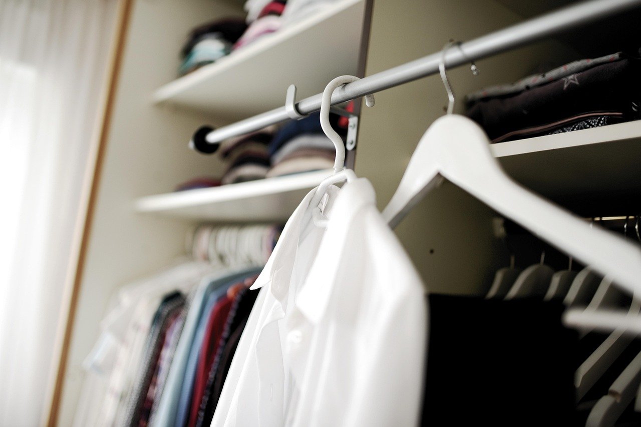 Closet with blazers, sweaters, and fall work outfits for women neatly stored with cedar blocks