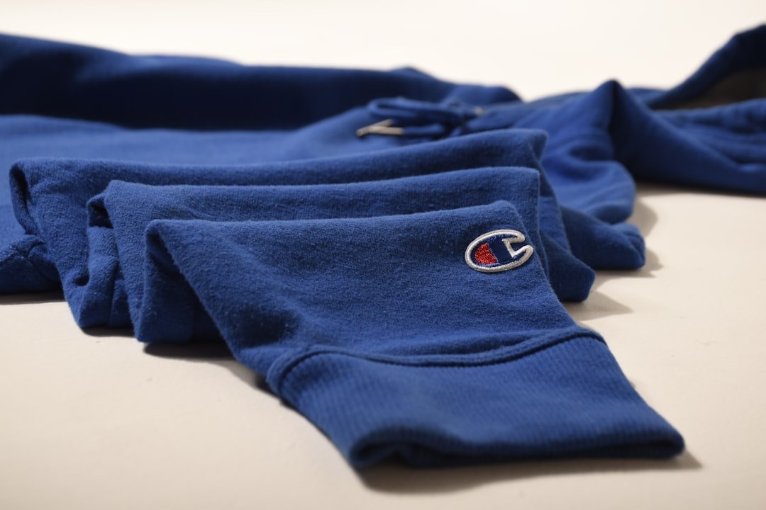 Stack of neatly folded winter sweatpants on a shelf with cozy home decor, showing how to care for and maintain them