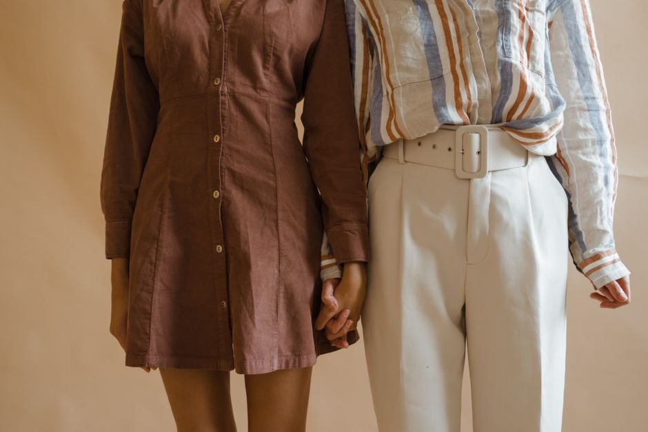 Models wearing brown outfits paired with rust, mustard, green, and cream fall colors.