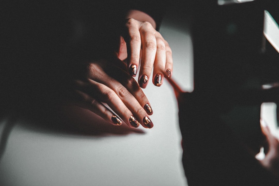 Cost-effective October nails using stylish press-ons in burgundy and pumpkin orange for affordable fall manicures.