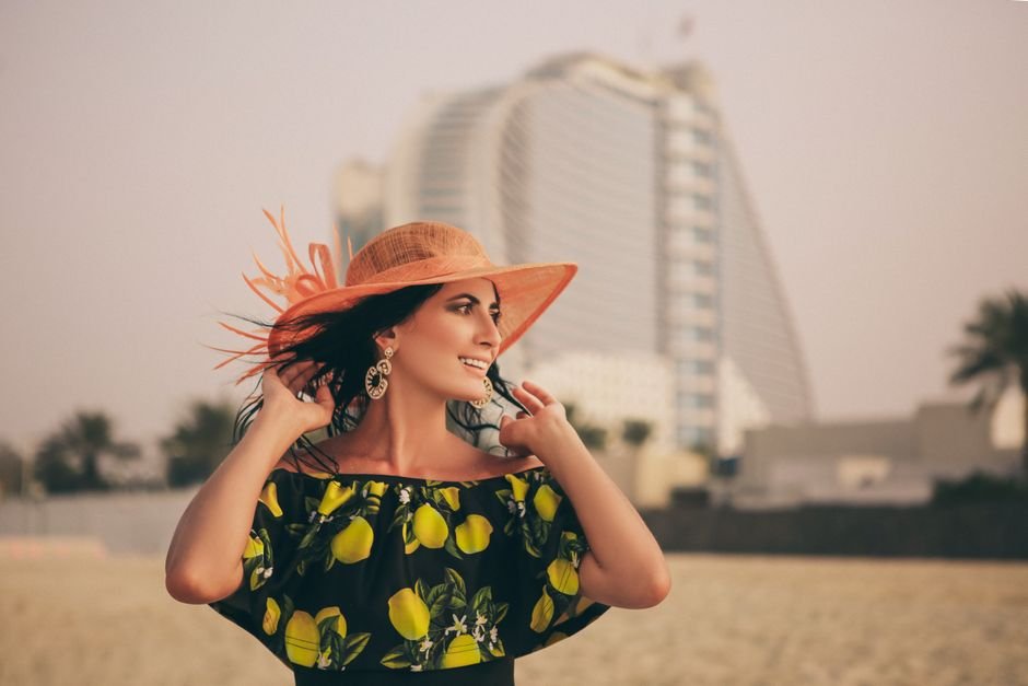 Essential pieces for elegant summer vacation outfits, including linen pants, silk camisole, and gold jewelry