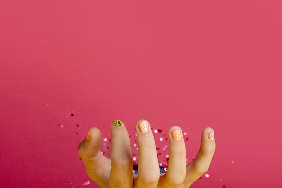 Easy DIY Halloween nail ideas with orange nails, spiderwebs, and ghost decals.