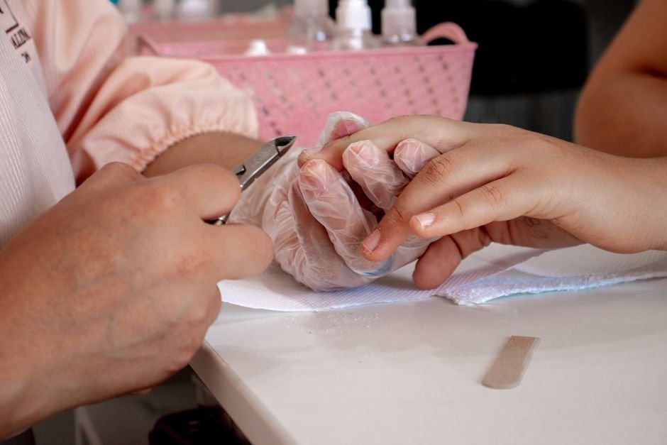 End of Summer Nails: Beautiful Transitional Designs & Colors 5 End of summer nail care flat lay with cuticle oil, moisturizer, and almonds beside manicured peach nails