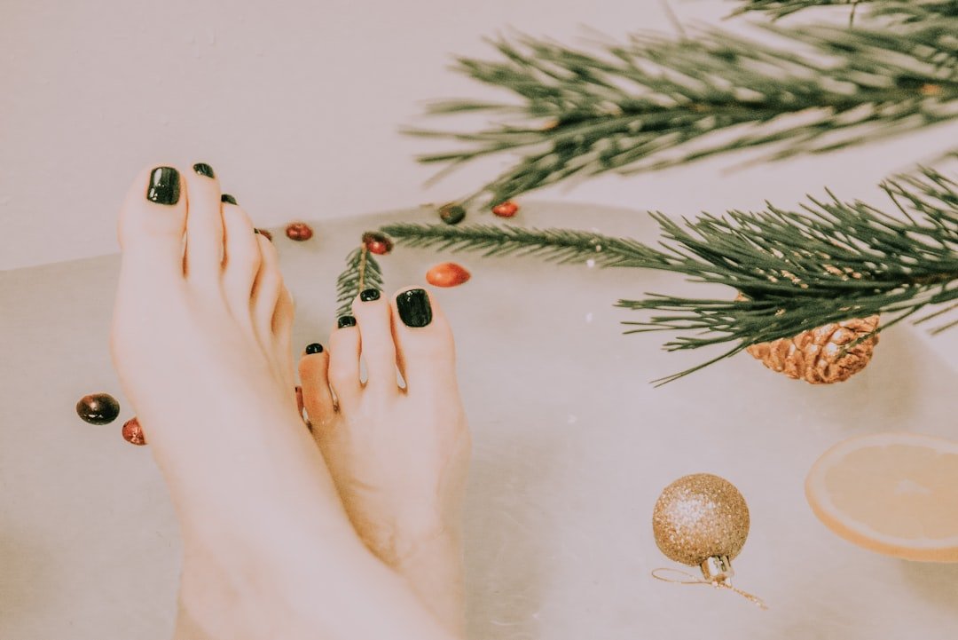 Christmas nail color palette with swatches of red, green, gold, silver, berry, and icy blue polish shades for simple Christmas nails