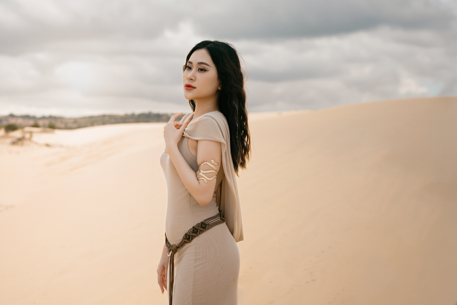 One-shoulder Grecian dress with gold embellishments and soft pleating for an elegant feminine look.