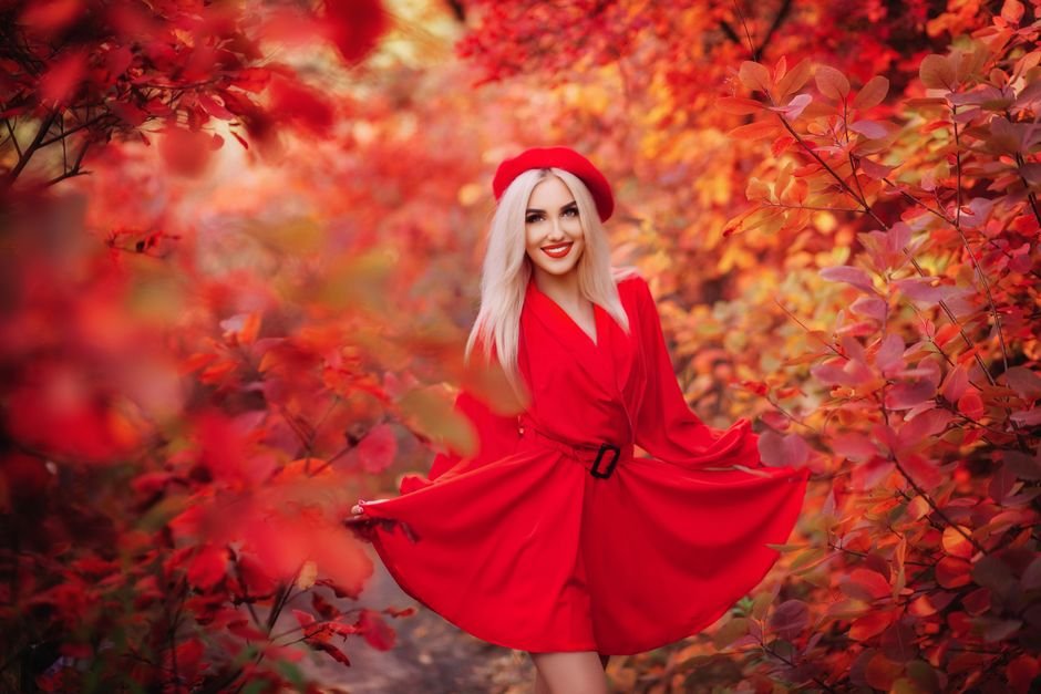 Model in a vibrant red silk blouse with red lipstick and gold accessories — showcasing red outfit ideas that prove red is fashion’s ultimate power color.