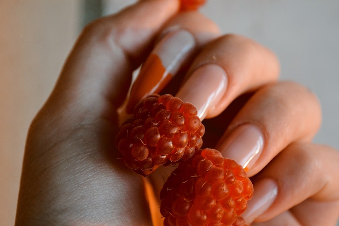 Three seasonal orange nail looks: light orange for early fall, burnt orange with Halloween accents, and orange-to-burgundy ombre for late fall