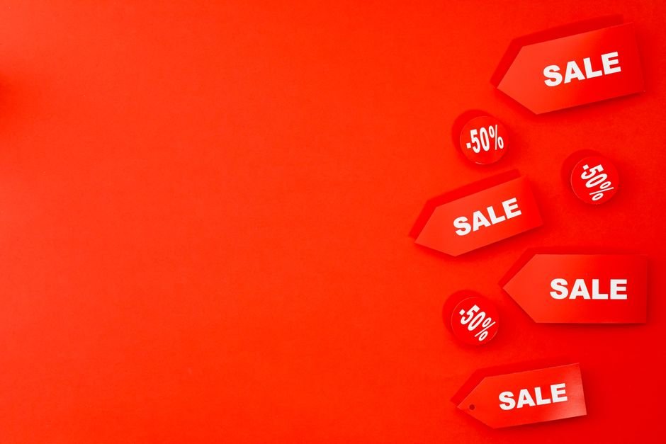Flat lay of red fashion items from designer handbags to affordable shoes — red outfit ideas for any budget