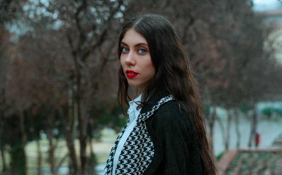 Woman with soft waves and minimal makeup styled to match the elegance of Old Money Outfits.