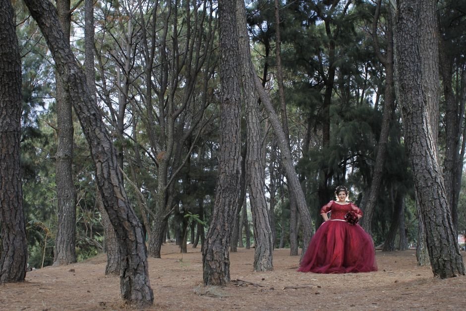 Plus size prom gown styled with elegant accessories and glam makeup