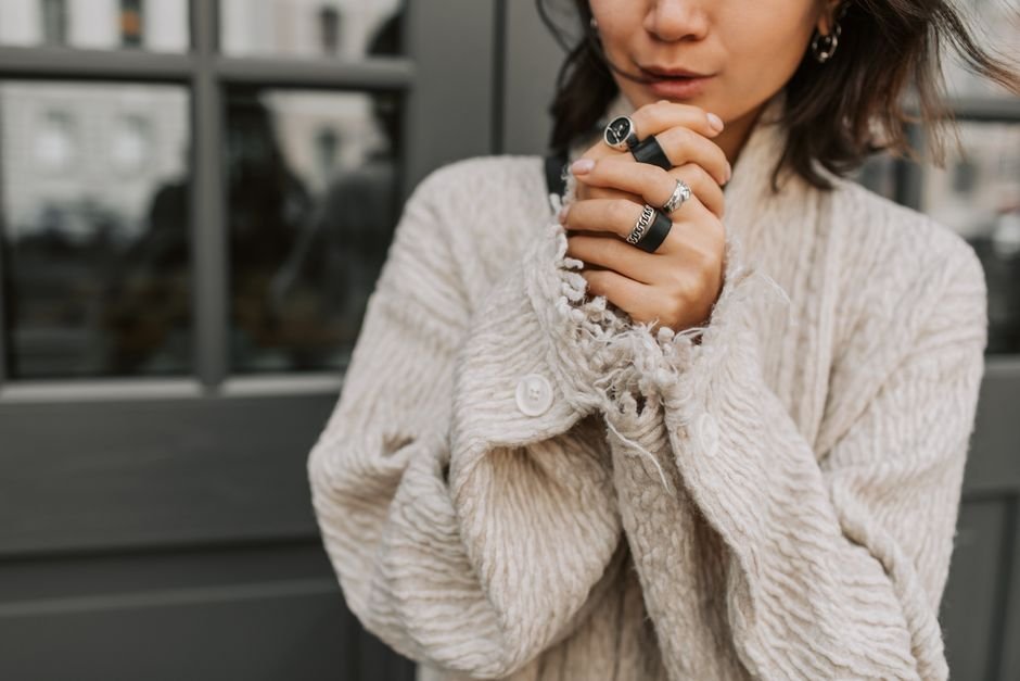 Curvy Spring Outfits: The Ultimate Guide to Dressing Your Body with Confidence This Season 4 Curvy woman in chunky sweater layered over floral slip dress with white sneakers, perfect winter-to-spring outfit transition