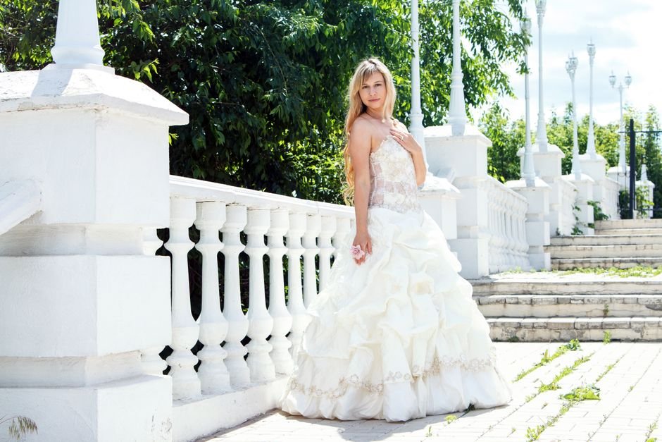 Elegant white summer dress styled for a garden party or special summer event.