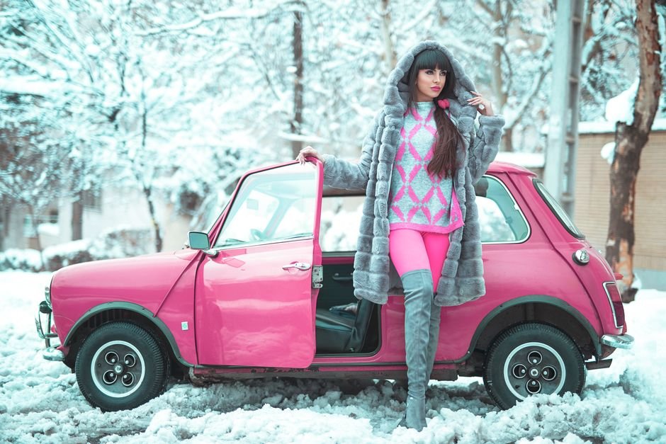 A cozy winter mini Uggs outfit perfect for cold days, featuring insulated leggings, a long wool coat, and knit accessories, blending warmth and style on a snowy urban street.