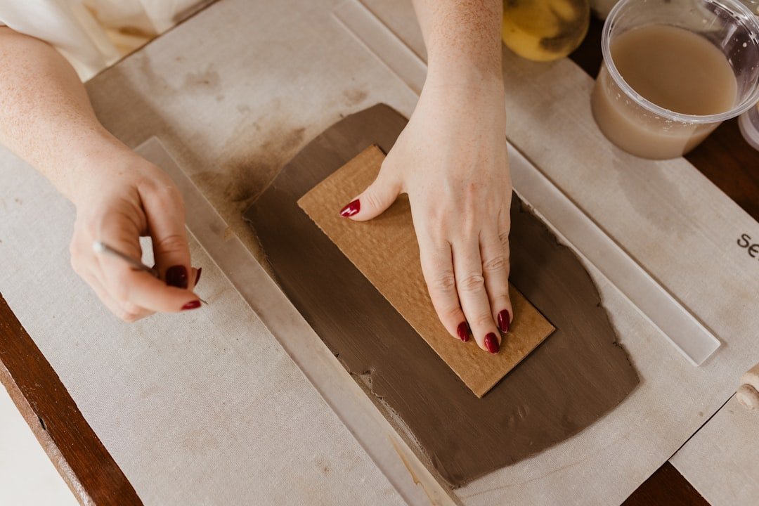 close-up of hand with finger nails being prepped for nail art and polish application prepping nail surface