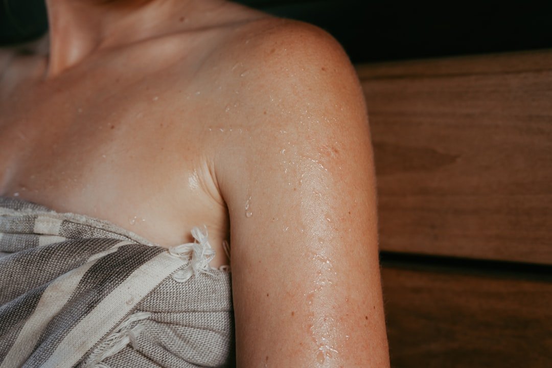 Woman applying moisturizer during hot and humid summer weather